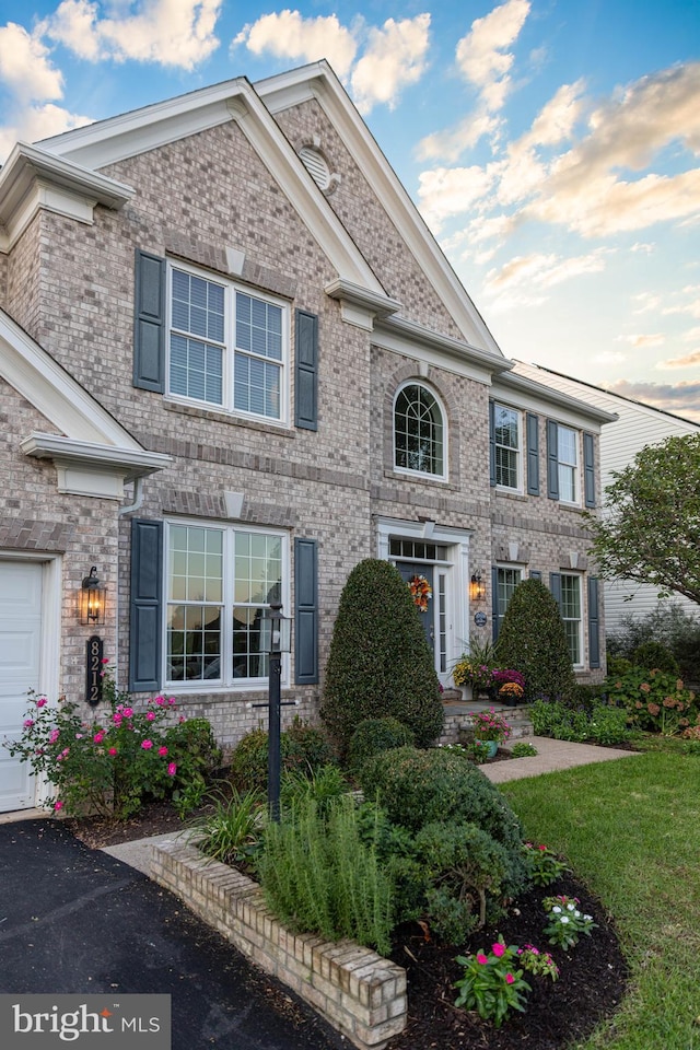 view of front of property featuring brick siding and an attached garage