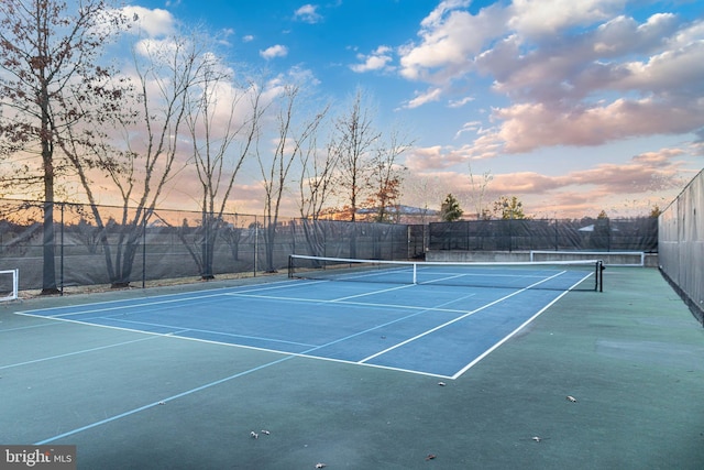 view of tennis court with fence