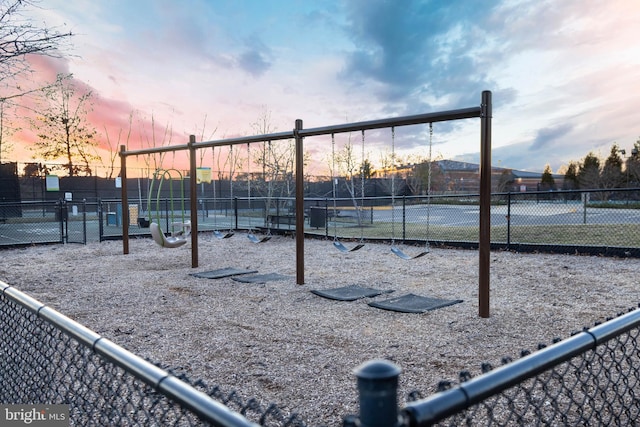 view of tennis court with playground community and fence