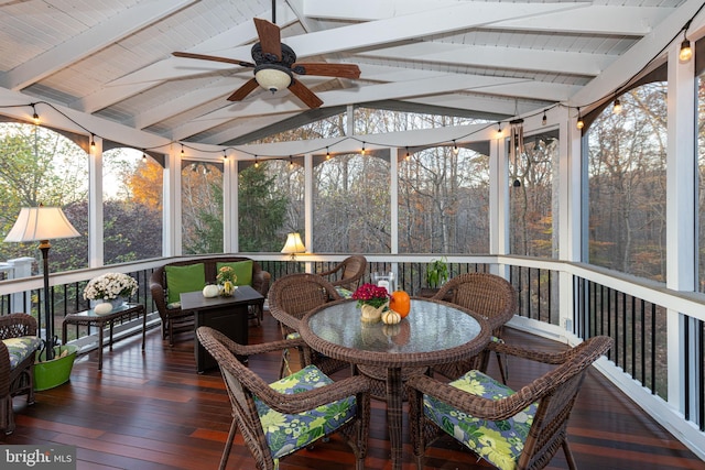 sunroom with vaulted ceiling with beams and a ceiling fan