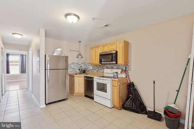 kitchen featuring light tile patterned floors, light brown cabinets, visible vents, appliances with stainless steel finishes, and tasteful backsplash