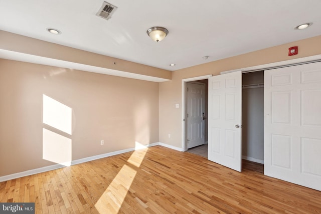 unfurnished bedroom with recessed lighting, visible vents, baseboards, a closet, and light wood-type flooring