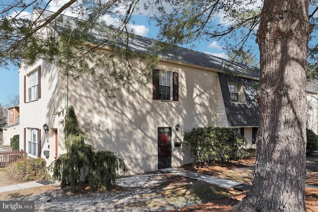 view of side of home with stucco siding