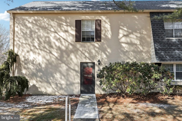 exterior space with roof with shingles