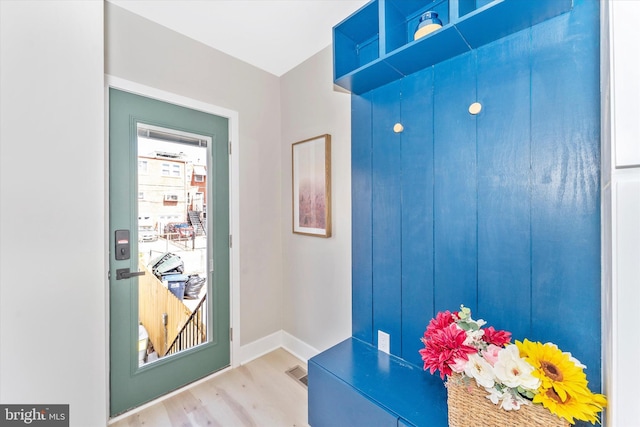 entrance foyer featuring visible vents, baseboards, and wood finished floors