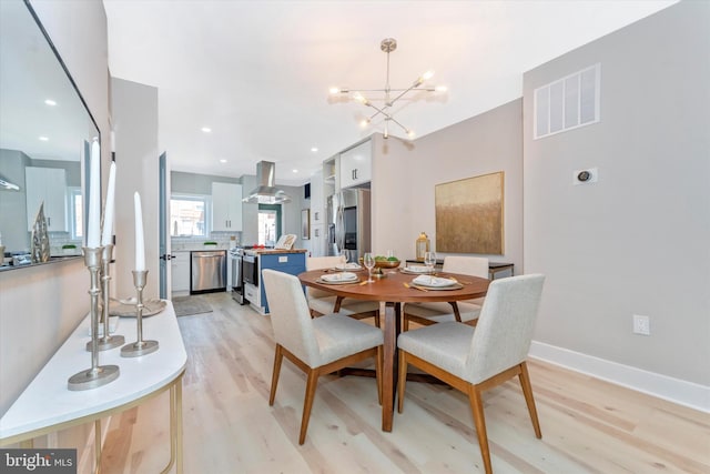 dining room featuring visible vents, baseboards, light wood-type flooring, recessed lighting, and an inviting chandelier