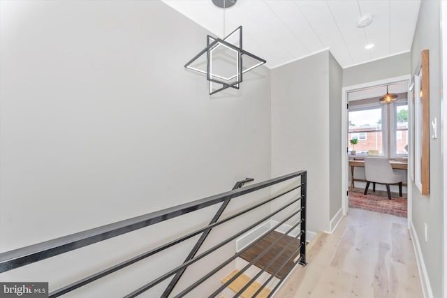 stairway with baseboards and wood finished floors