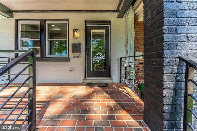 doorway to property with brick siding