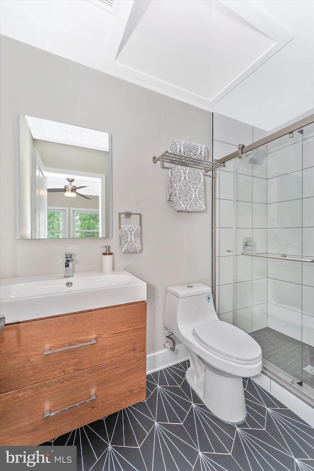 full bath featuring vanity, baseboards, a stall shower, tile patterned flooring, and toilet