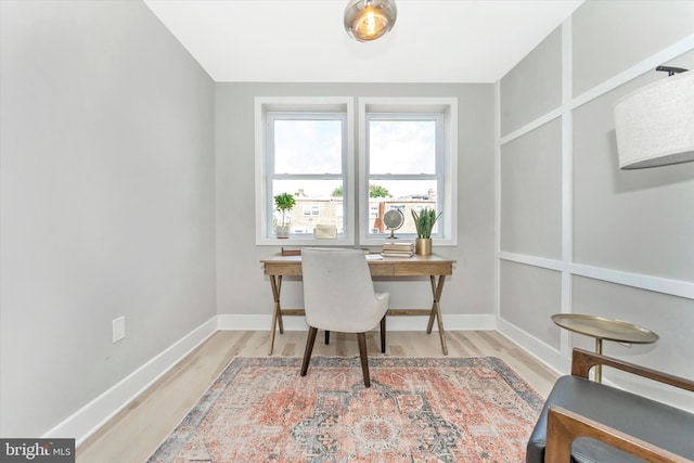 office area with baseboards and wood finished floors