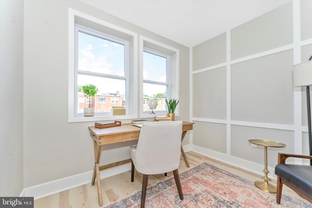 office featuring light wood-type flooring and baseboards