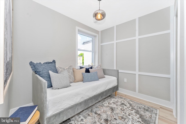 bedroom featuring wood finished floors and baseboards