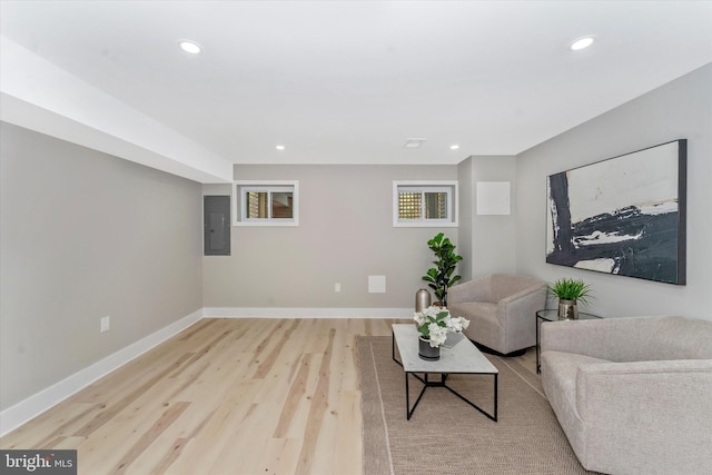 sitting room with electric panel, recessed lighting, baseboards, and light wood finished floors