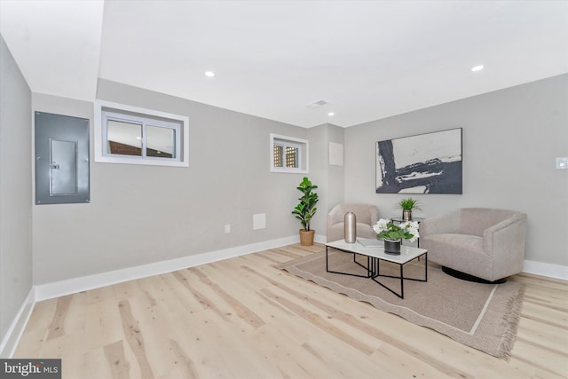 sitting room with wood finished floors, visible vents, baseboards, electric panel, and recessed lighting