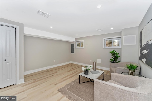 living area with visible vents, electric panel, wood finished floors, recessed lighting, and baseboards