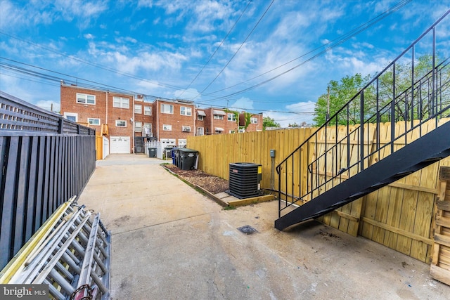 exterior space with central air condition unit and fence