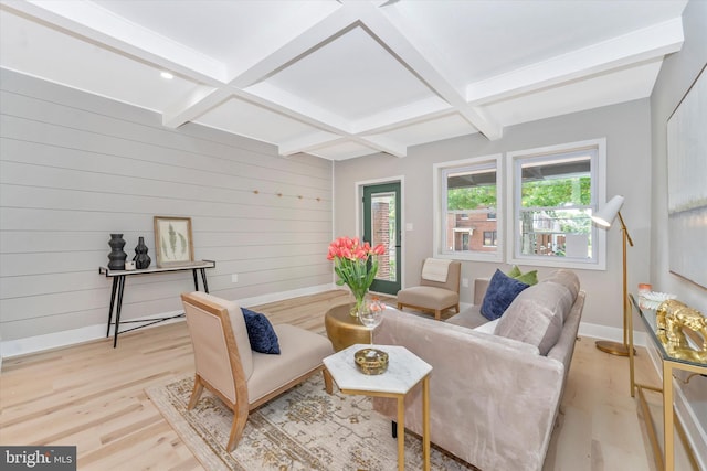 living room featuring light wood-type flooring, beam ceiling, coffered ceiling, and baseboards