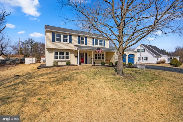 view of front of home featuring brick siding, a porch, a garage, driveway, and a front lawn