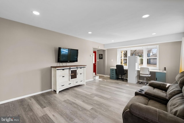 living area with baseboards, wood finished floors, and recessed lighting