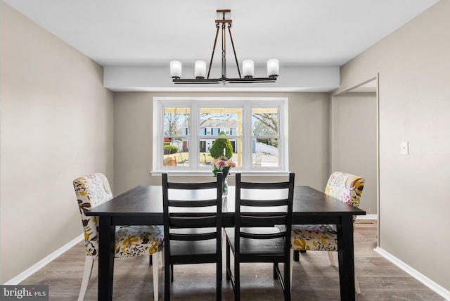 dining room with an inviting chandelier, wood finished floors, and baseboards