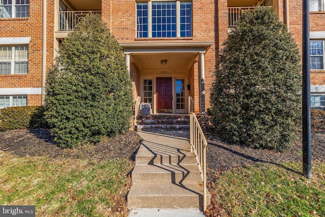 doorway to property with brick siding