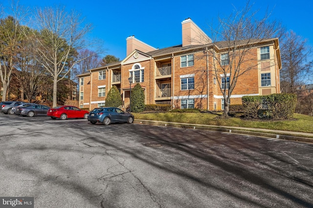 view of property with uncovered parking