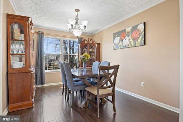 dining area with dark wood-style floors, baseboards, a chandelier, and ornamental molding