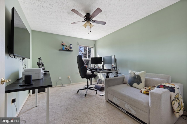 office space featuring ceiling fan, a textured ceiling, baseboards, and carpet flooring