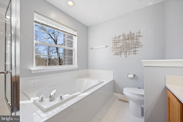 bathroom with visible vents, a bath, vanity, and tile patterned floors