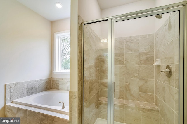 full bath featuring a stall shower and a bath