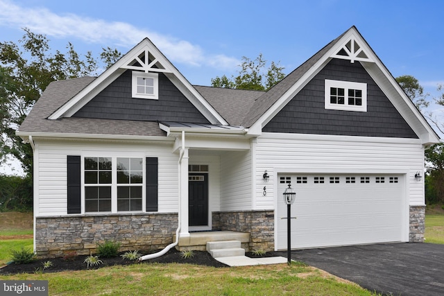 craftsman house featuring stone siding, a shingled roof, and aphalt driveway