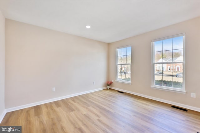 unfurnished room featuring visible vents, recessed lighting, light wood-style flooring, and baseboards