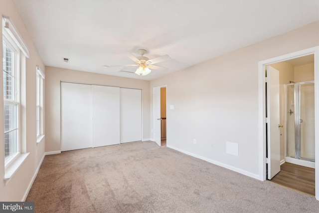 unfurnished bedroom featuring a ceiling fan, a closet, carpet flooring, and baseboards