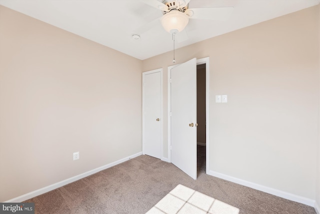 unfurnished bedroom with ceiling fan, baseboards, and carpet flooring