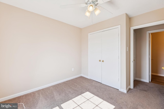 unfurnished bedroom with carpet, baseboards, and a closet