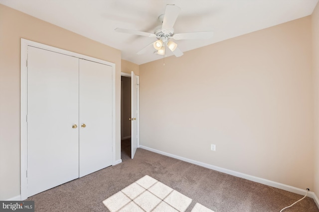 unfurnished bedroom with a ceiling fan, carpet, baseboards, and a closet