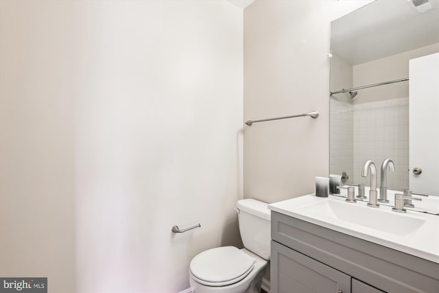 bathroom featuring visible vents, vanity, and toilet