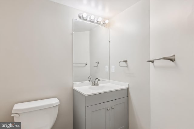 bathroom featuring toilet and vanity