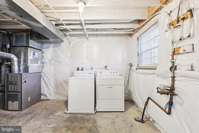 basement with heating unit and separate washer and dryer