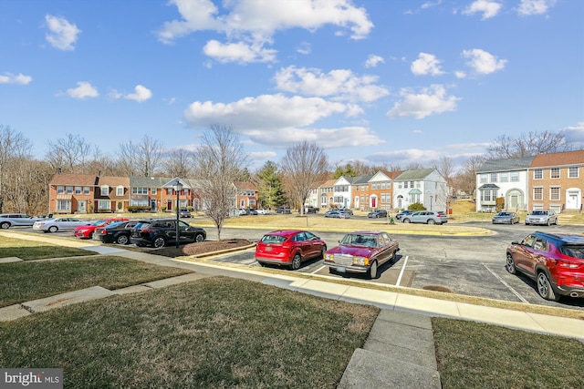 uncovered parking lot featuring a residential view