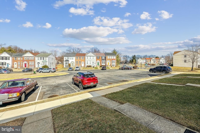 view of road with sidewalks, a residential view, and curbs