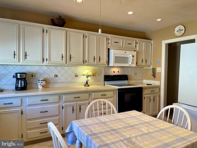 kitchen featuring white appliances, light tile patterned floors, light countertops, and decorative backsplash