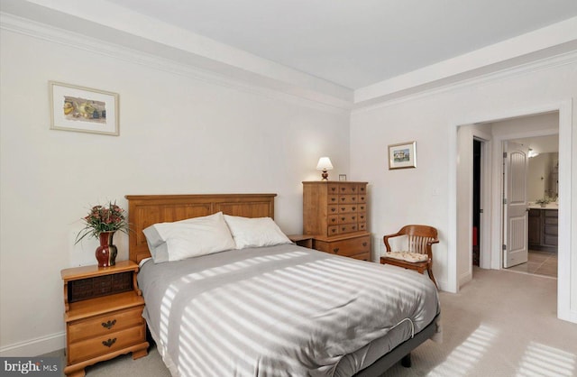 bedroom featuring light carpet, baseboards, and ornamental molding