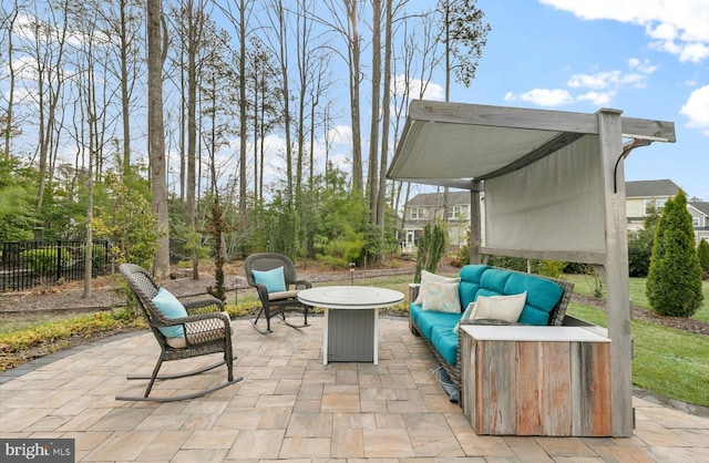 view of patio featuring an outdoor living space with a fire pit and fence