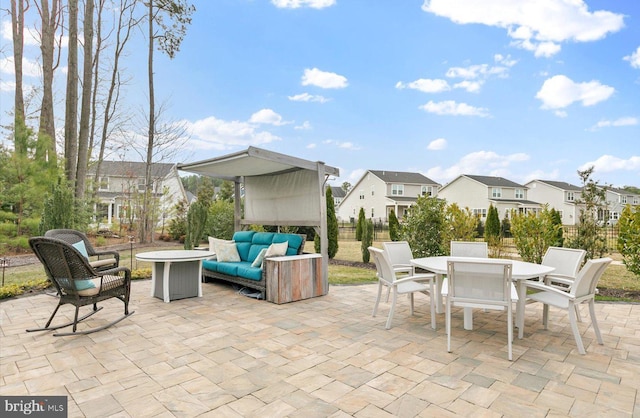 view of patio with a residential view, an outdoor living space, outdoor dining area, and fence