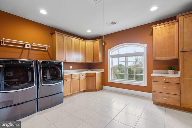 laundry area with baseboards, washer and clothes dryer, cabinet space, and recessed lighting