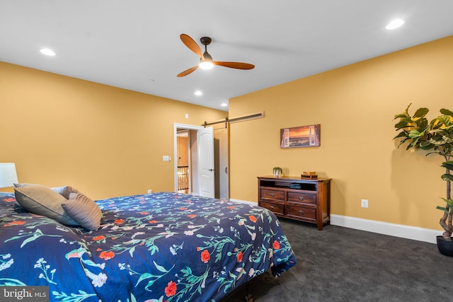 carpeted bedroom featuring a barn door, baseboards, a ceiling fan, and recessed lighting