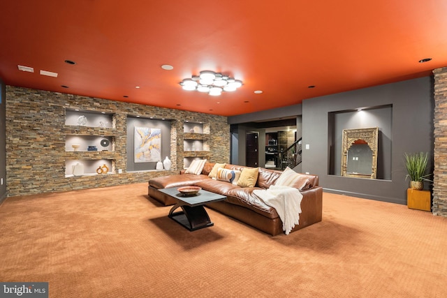 living room with carpet, a fireplace, and stairs