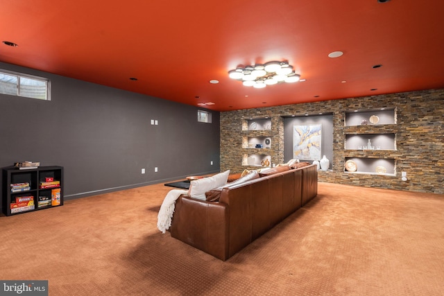 carpeted cinema room featuring baseboards