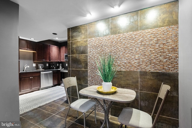 dining area featuring tile walls, dark tile patterned floors, and recessed lighting